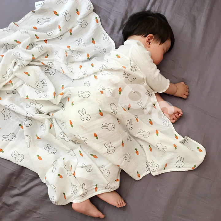 Baby Care holding a blanket towel